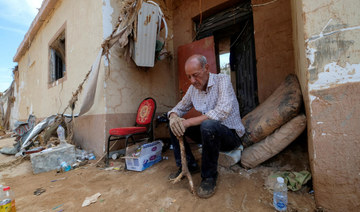 Hassan Kassar sits outside his damaged house, in Derna, Libya September 17, 2023. (Reuters)