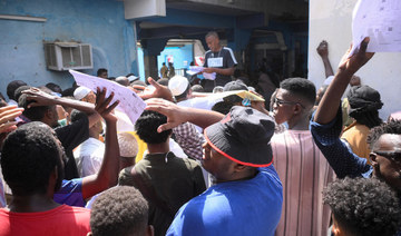 Sudanese citizens gather to renew their passports in the city of Port Sudan, Sudan, September 24, 2023. (Reuters)