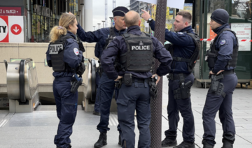 Police stand outside the Bibliotheque Francois Mitterrand metro and regional train station in Paris, France, October 31, 2023. 