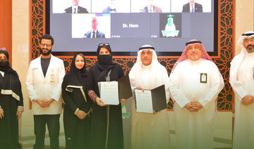 Officials pose for a group photo after signing the deal. (Photo: Twitter @kauweb)