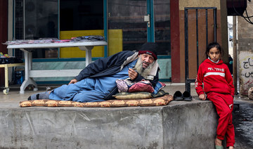 A displaced Palestinian man and child are pictured in Rafah in the southern Gaza Strip on Dec. 27, 2023. (AFP)