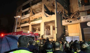 Lebanese emergency responders gather at the site of a strike targeting a Hamas office, in the southern suburb of Beirut.