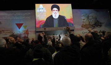 People watch the televised speech of Lebanon’s Hezbollah chief Hasan Nasrallah.