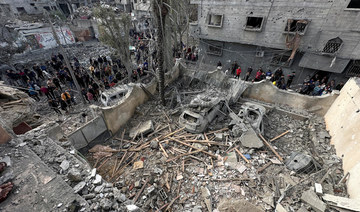 Palestinians inspect the site of an Israeli strike on a house, amid the ongoing conflict between Israel and Hamas, in Jabalia.