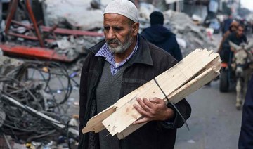 A man carries firewood in Rafah in the southern Gaza Strip on Jan. 14, 2024. (AFP)