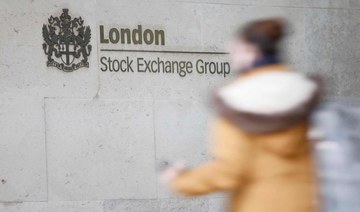 A pedestrian walks past the logo for the London Stock Exchange Group outside the stock exchange in London. (File/AFP)