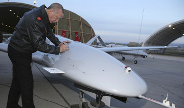 Turkiye's President Recep Tayyip Erdogan signs a drone at a military airbase in Batman, Turkey. (AP file photo)