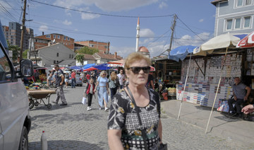 People walk in a market in Pristina, on September 29, 2023. (AFP)