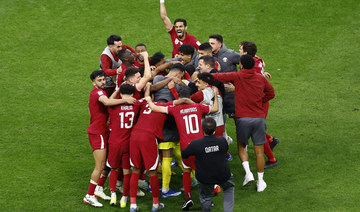 Qatar players celebrate after the match upon reaching the semifinals. (Reuters)