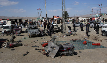 Members of a bomb disposal squad examine the site of a blast in Khanozai, Balochistan, Pakistan, February 7, 2024. (Reuters)