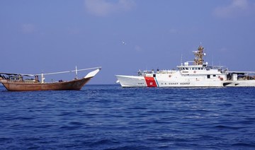 A US navy cutter can be seen next to a vessel reportedly carrying a shipment of Iranian weapons destined for the Houthis.