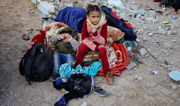 Children rest outside, as Palestinians arrive in Rafah after they were evacuated from Nasser hospital in Khan Younis.