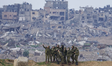 Israeli female soldiers pose for a photo on a position on the Gaza Strip border, in southern Israel, Monday, Feb. 19, 2024. (AP)