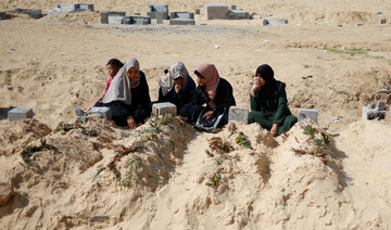 Palestinians visit a cemetery, amid the ongoing conflict between Israel and Hamas, in Rafah in the southern Gaza Strip.