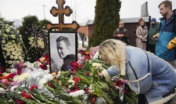 Russians lay flowers at Navalny’s grave, hail him as symbol of hope