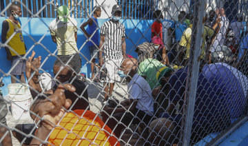 Hundreds of inmates flee after armed gangs storm Haiti’s main prison, leaving bodies behind