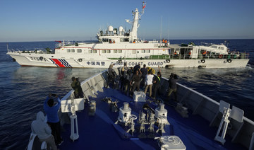 China coast guard flexes its might against the Philippines in disputed waters as journalists look on