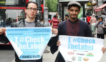 Protesters hold a banner promoting the #CheckTheLabel boycott campaign of Israeli dates in the United Kingdom. (FOA)