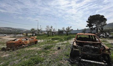 Burnt car carcasses rust in a field near a Palestinian auto garage which was reportedly attacked by Israeli settlers in Huwara.