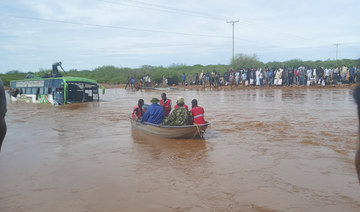 Passengers of a bus that was swept away by floodwaters are rescued by boat, near Garissa, northern Kenya, Tuesday, April 9, 2024