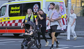 People are led out from the Westfield Shopping Centre where multiple people were stabbed in Sydney, Saturday, April 13, 2024. 