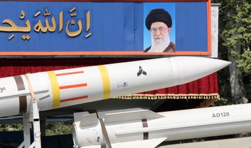 An Iranian military truck carries parts of a Sayad 4-B missile past a portrait of supreme leader Ayatollah Ali Khamenei.