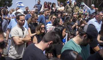 People mourn in grief during the funeral for Israeli reserve Major Dor Zimel in Even Yehuda, Israel, on Monday, April 22, 2024. 