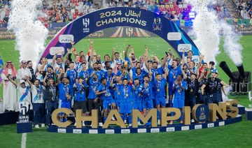 Al Hilal's Salem Al Dawsari lifts the trophy with teammates after winning the Saudi Super Cup final in Abu Dhabi. Reuters