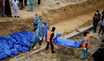The bodies of Palestinians killed in Israeli strikes are buried in a mass grave.