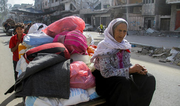 Displaced Palestinians, who fled Jabalia after the Israeli military called on residents to evacuate, travel in a cart.