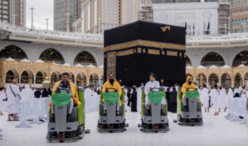 Employees remove water from the mataf during rainfall at the Grand Mosque in Makkah. (@AlharamainSA)