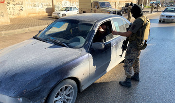 A member of the Libyan security forces checks a driver's document as they are deployed in Misrata, Libya. (REUTERS)