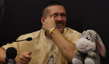 Usyk in tears for late father after historic heavyweight win