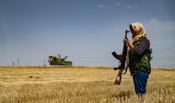 Armed Syrian Kurdish women stand guard over precious wheatfields