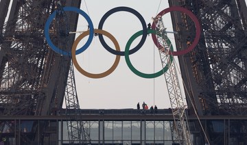 Paris Olympics organizers unveil a display of the five Olympic rings mounted on the Eiffel Tower