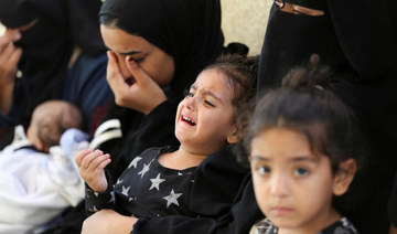 Mourners react next to the bodies of Palestinians, killed in Israeli strikes due to a military operation in Rafah.