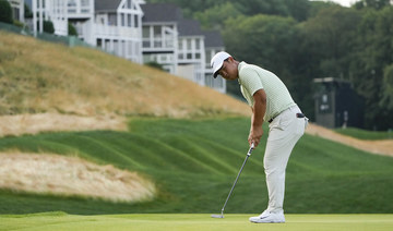 Tom Kim clings to a 1-shot lead over Scheffler and Bhatia in rain-delayed Travelers