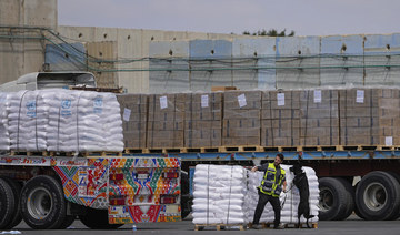 Trucks carrying humanitarian aid for the Gaza Strip pass through the inspection area at the Kerem Shalom Crossing.