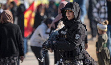  A female member of the Syrian Kurdish Asayish security forces stands guard in Qamishli in northeastern Syria. (AFP)