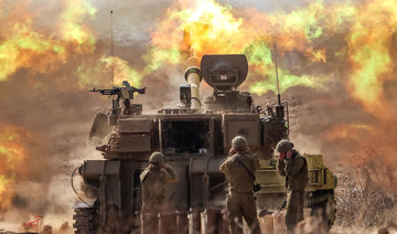 An Israeli army M109 155mm self-propelled howitzer fires rounds near the border with Gaza in southern Israel on October 11, 2023