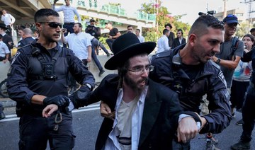 Police detain an ultra-Orthodox Jewish man during a protest against a ruling by a top Israeli court.