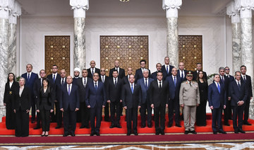 Egyptian President Abdel-Fattah El-Sissi poses with Egypt’s new cabinet, led by Prime Minister Mostafa Madbouly, fourth left.