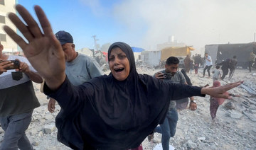 Palestinians react, following an Israeli strike near a UN-run school sheltering displaced people in Khan Younis.
