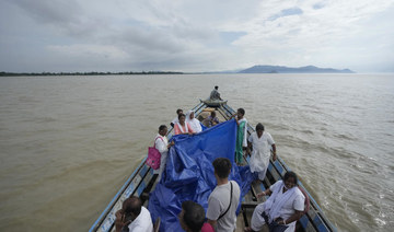 Indian mother delivers baby on boat as her river island is inundated by floodwaters