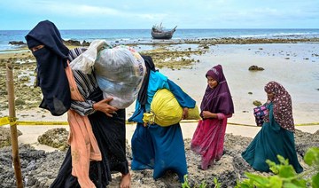 Rohingya women refugees leave the beach for their tents at Balohan ferry port in Sabang, Indonesia’s Aceh province. (File/AFP) 