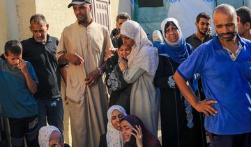 Palestinians mourn over the bodies of loved ones following Israeli bombardment in Deir El-Balah in the central Gaza Strip.