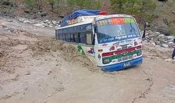 Search for dozens missing after landslide sweeps buses into Nepal river is suspended