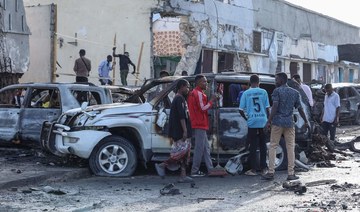 People look at the destruction at a cafe in Mogadishu on July 15, 2024 following a car bomb blast.