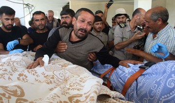 Relatives and friends mourn over the bodies of three children killed in Israeli strikes during their funeral in Al-Qasmiya area.