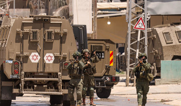 Israeli army soldiers take position during a raid in the Nur Shams camp for Palestinian refugees in the occupied West Bank. 